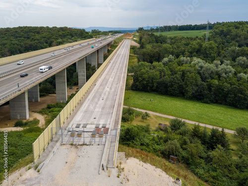 Aerial view of a German Autobahn with construction works for a new railway bridge next to it. Drone photo taken at Denkendorf near Stuttgart - on a weekend, hence not much truck traffic. photo