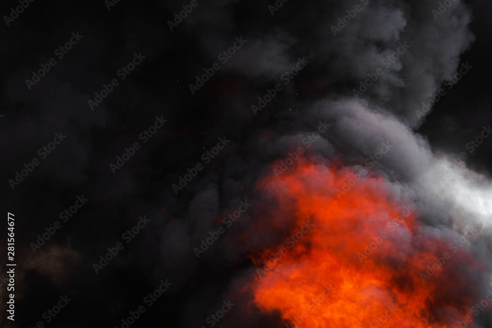 Flames strong red fire, dramatic clouds motion blur of black smoke covered sky