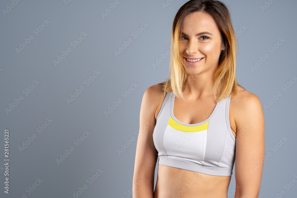 Young sporty fit caucasian female model on gray background Young sporty fit caucasian female model on gray background
