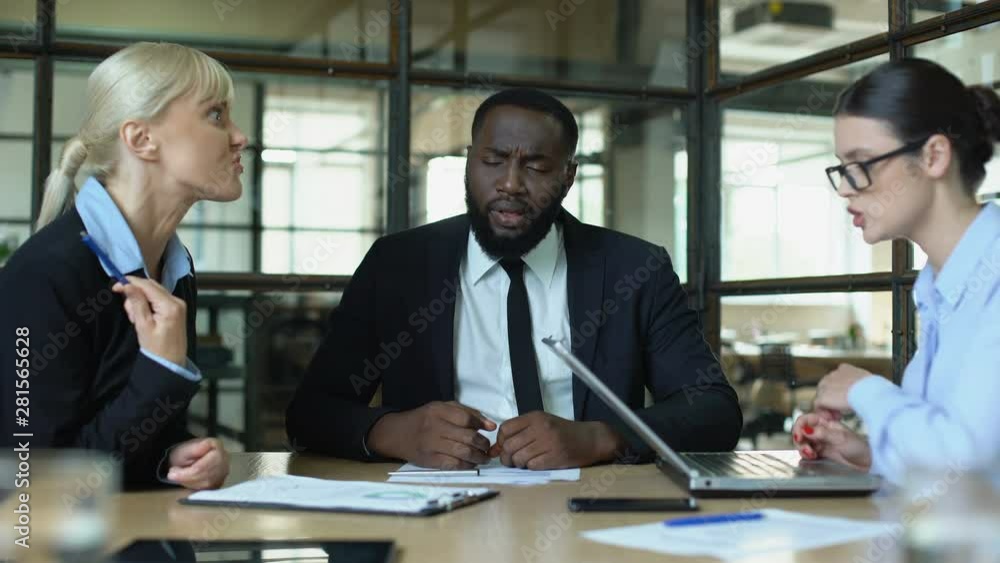 Meditating businessman in office feeling tired of shouting female conflicts Meditating businessman in office feeling tired of shouting female conflicts