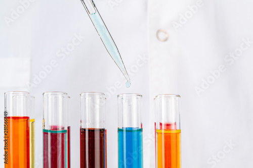 Chemist hands holding test tubes with liquids and doing experiments