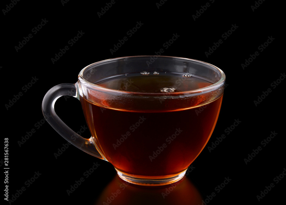 Glass cup of tea on black background Glass cup of tea on black background