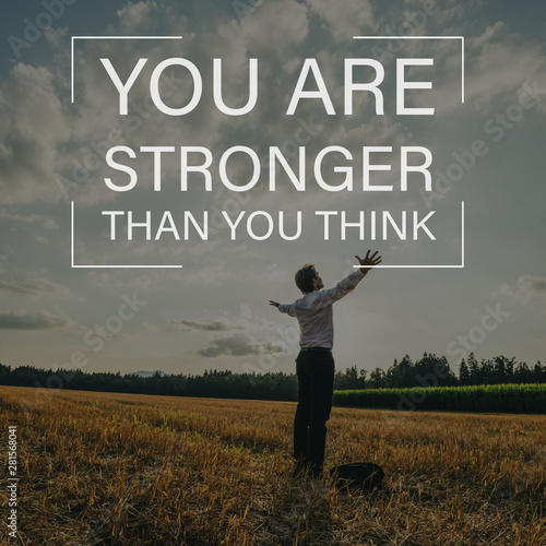 You are stronger than you think sign over a businessman standing in nature