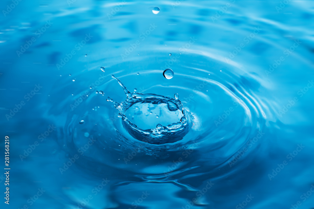 Water drops on blue surface. Water ripple background. Splashes from a drop of water. Raindrops on a blue background. The texture of the water. Aqua, turquoise, macro Water drops on blue surface. Water ripple background. Splashes from a drop of water. Raindrops on a blue background. The texture of the water. Aqua, turquoise, macro