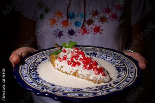Chile en nogada platillo típico de Puebla México servido en plato de talavera photo