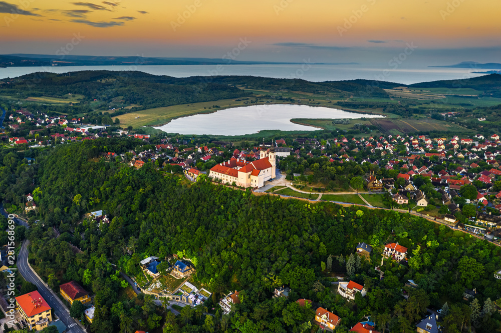Tihany, Hungary - Panoramic view of the beautiful village of Tihany on the northern shore of Lake Balaton with the Benedictine Monastery of Tihany (Tihanyi apatsag), Inner Lake with a golden sunrise