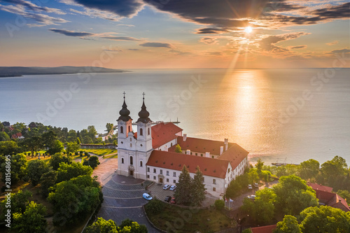 Tihany, Hungary - Aerial skyline view of the famous Benedictine Monastery of Tihany (Tihany Abbey) with beautiful colourful sky and clouds at sunrise over Lake Balaton photo
