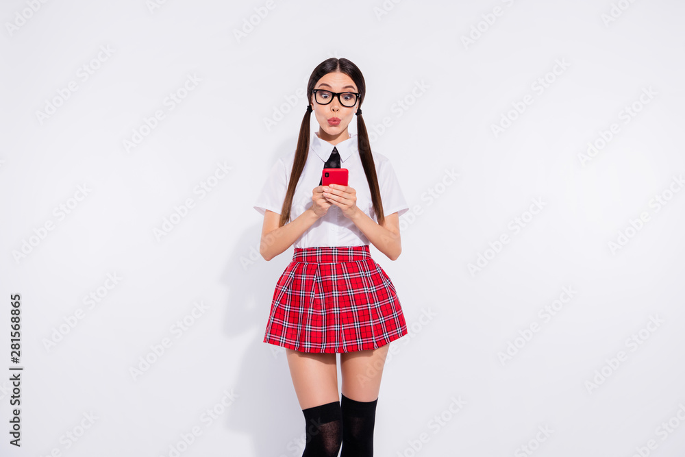 Portrait of her she nice attractive lovely glamorous funny funky girl wearing checked skirt holding in hands cell user chatting texting typing isolated on gray light white background Portrait of her she nice attractive lovely glamorous funny funky girl wearing checked skirt holding in hands cell user chatting texting typing isolated on gray light white background