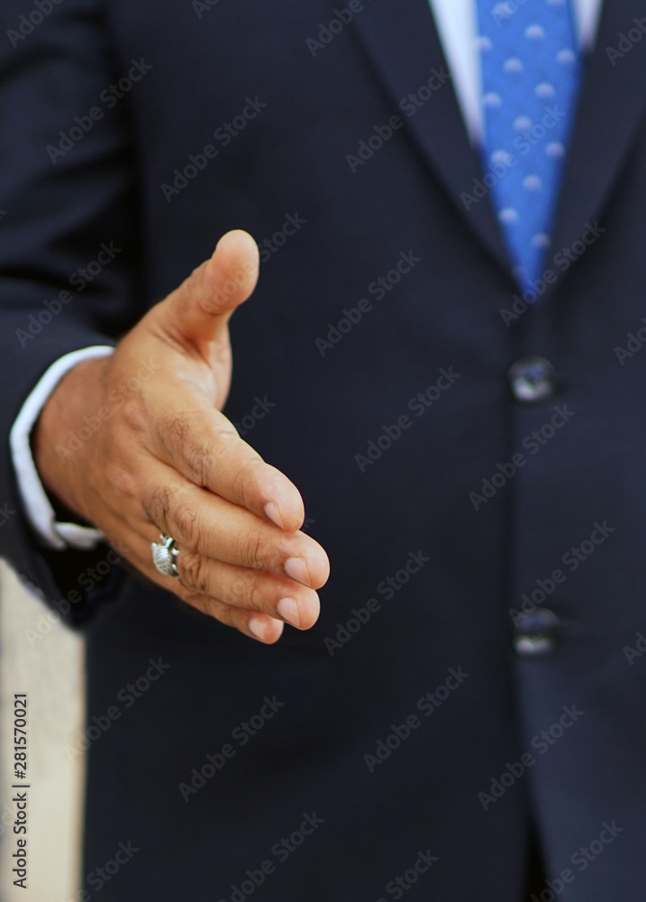 Business man or employee putting forward hand for handshake to introduce                                