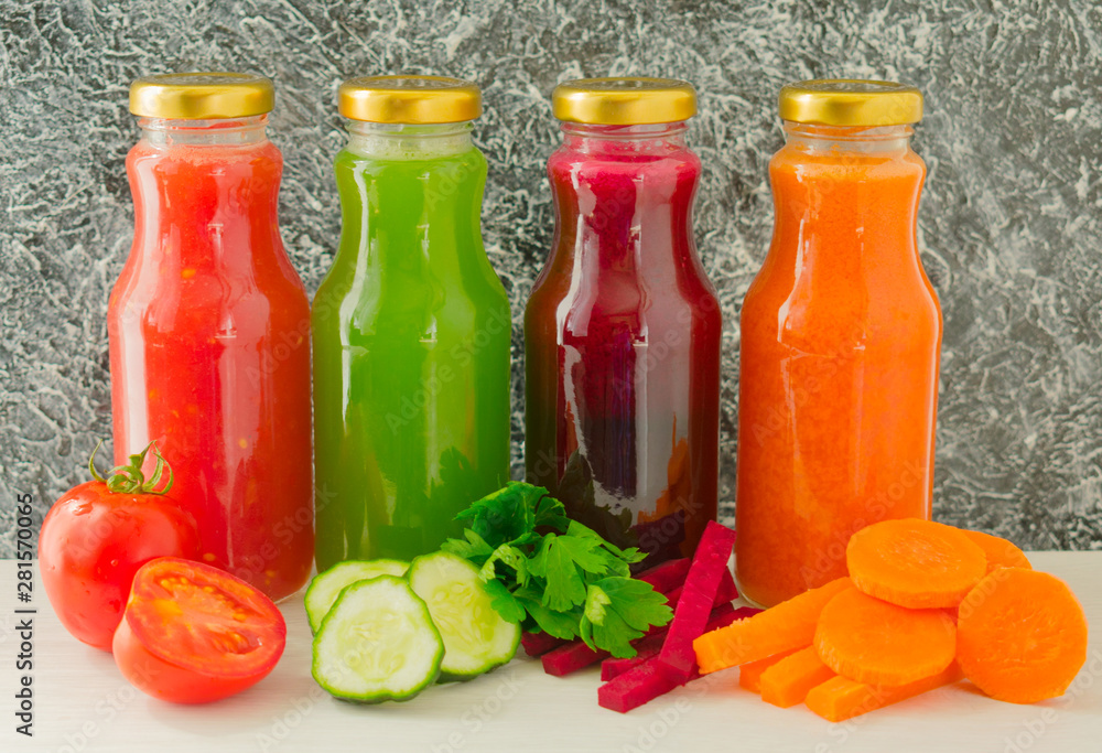 Four vegetable juices in glass bottles. A large plan. The concept of healthy eating. Four vegetable juices in glass bottles. A large plan. The concept of healthy eating.