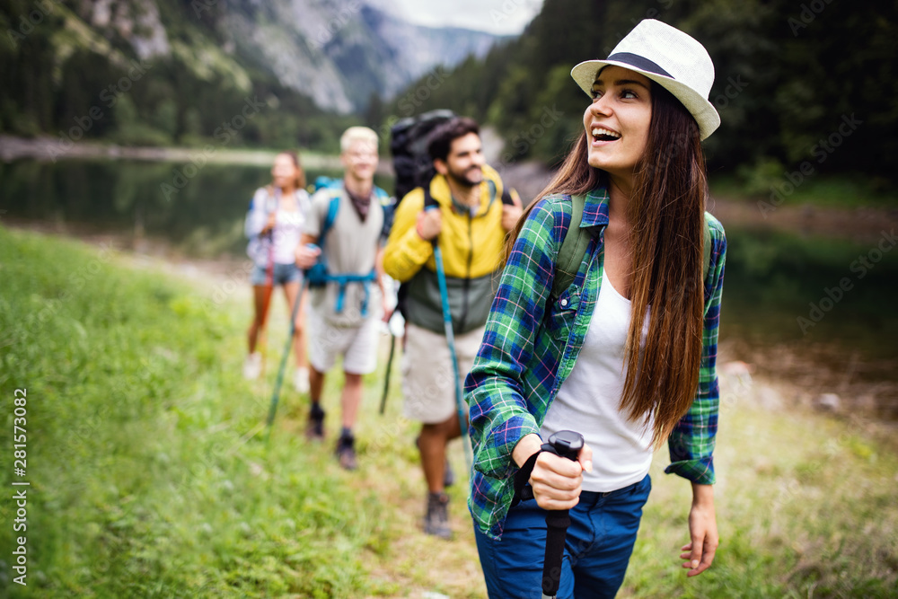 Trekking, camping, hiking and wild life concept. Group of friends are hiking in nature Trekking, camping, hiking and wild life concept. Group of friends are hiking in nature
