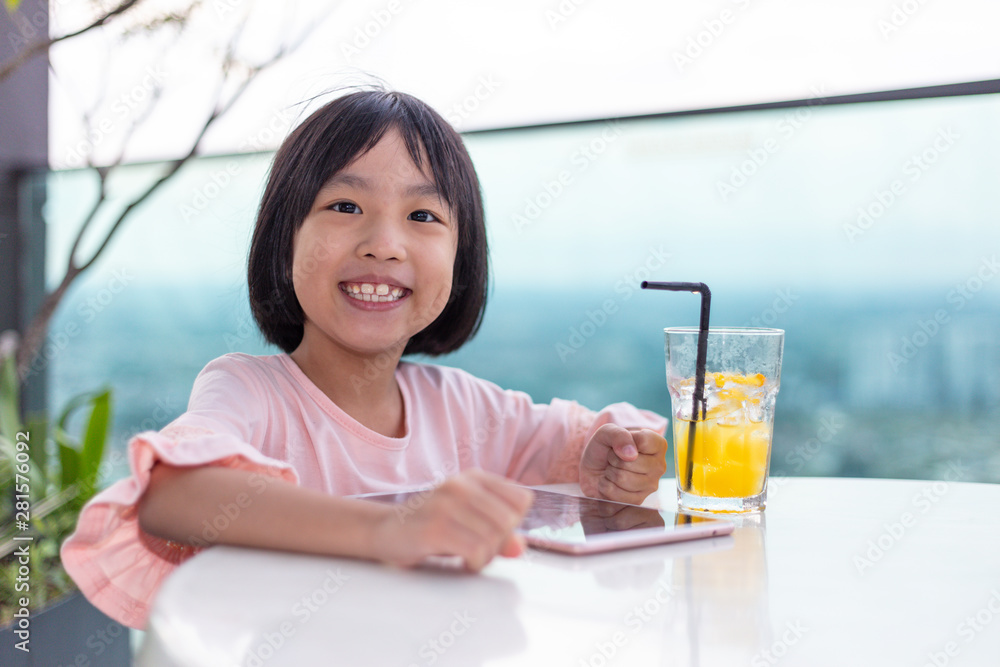 Asian Little Chinese Girl playing with tablet Asian Little Chinese Girl playing with tablet