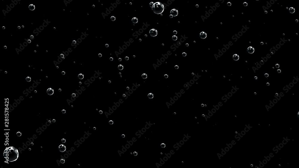 Sparkling water in the glass bubbles going up slow-mo motion. Bubbles are filled with carbon dioxide and float upwards. Sparkling water in the glass bubbles going up slow-mo motion. Bubbles are filled with carbon dioxide and float upwards.