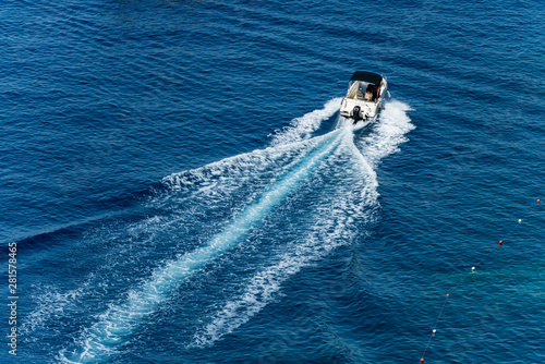 Картината върху платно White motorboat in motion with wake in the blue Mediterranean sea photographed from above
