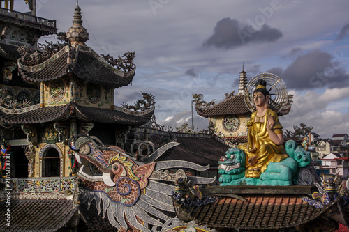 Buddha sitting on the roof and dragon in the Linh Phuoc Pagoda at city of Dalat Vietnam