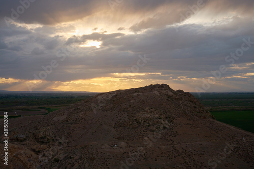 View from the top of the mountain at sunset, clouds in the sky. © StockAleksey