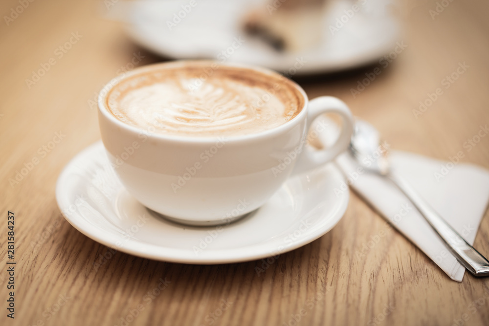 Hot coffee cappuccino latte art on wooden background Hot coffee cappuccino latte art on wooden background