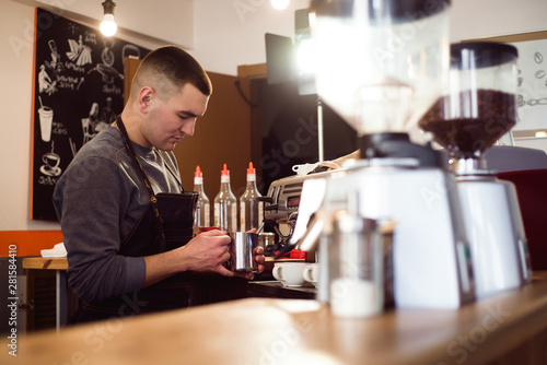 Barista making coffee using a coffee machine, hospitality and hot beverage concept.