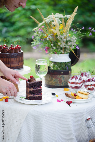 Delicious chocolate cake  red velvet in a glass  wild flowers  berries.