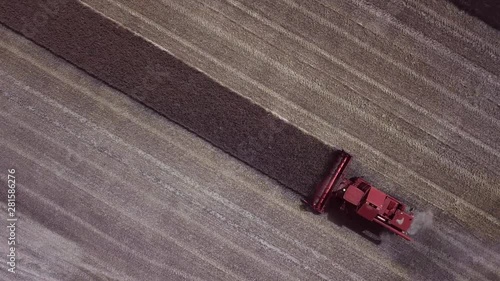 top view aerial of a harvester cropping a field