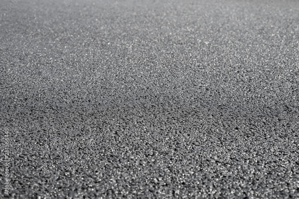A new dark grey asphalt pavement texture. A new dark grey asphalt pavement texture.