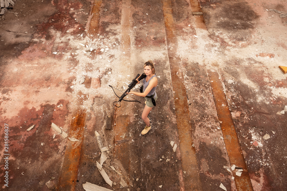 Fototapeta premium Young beautiful woman posing in airsoft game photoshooting