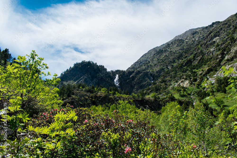 Landscape with waterfall in the mountains in summer at Parc Natural del Comapedrosa, Arinsal, Andorra Landscape with waterfall in the mountains in summer at Parc Natural del Comapedrosa, Arinsal, Andorra