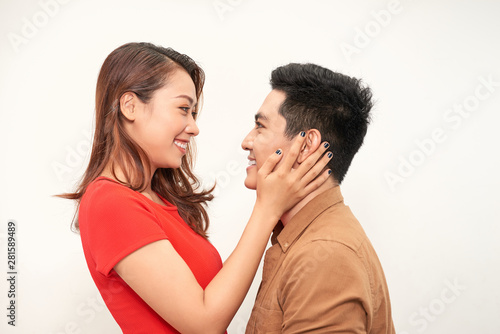 Handsome man picking up and hugging his girlfriend isolated on white background