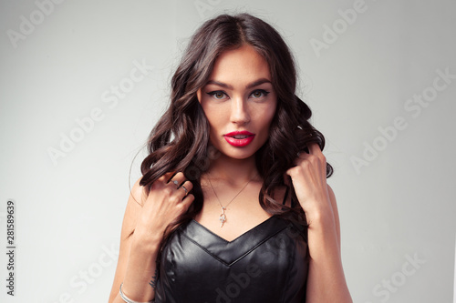 Asian model fashion girl portrait in black leather dress