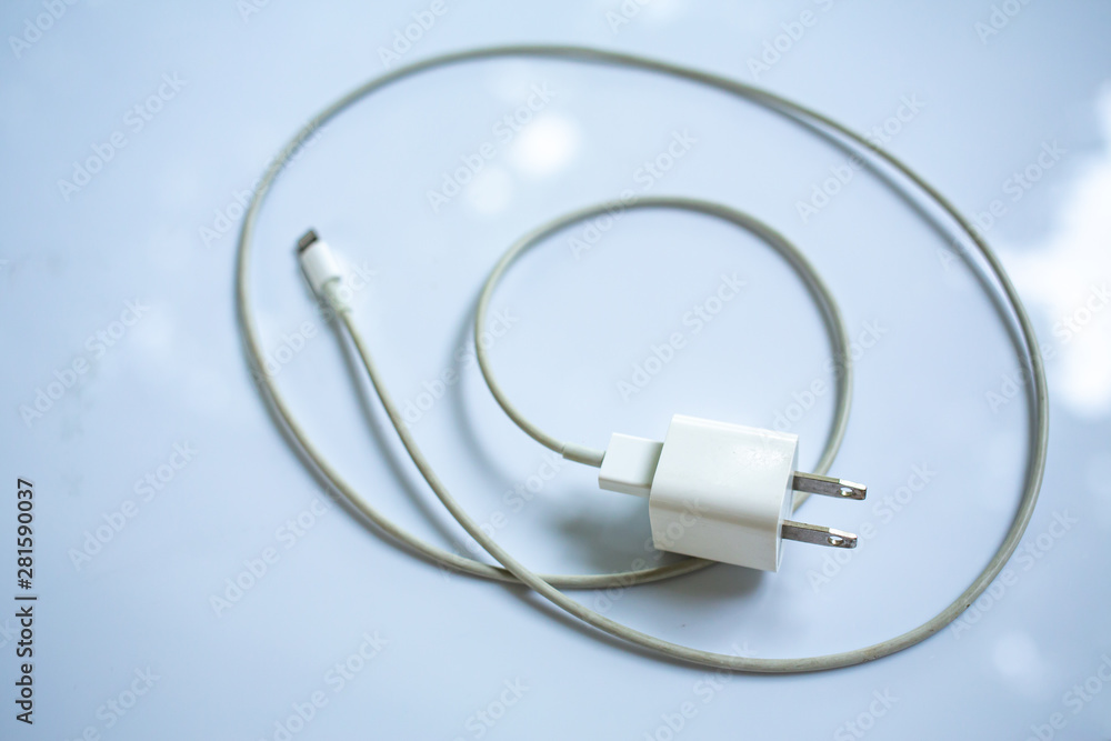 Smart Phone Charger Cable on white acrylic table background, Close up & Macro shot, Selective focus, Technology, Business concept Smart Phone Charger Cable on white acrylic table background, Close up & Macro shot, Selective focus, Technology, Business concept