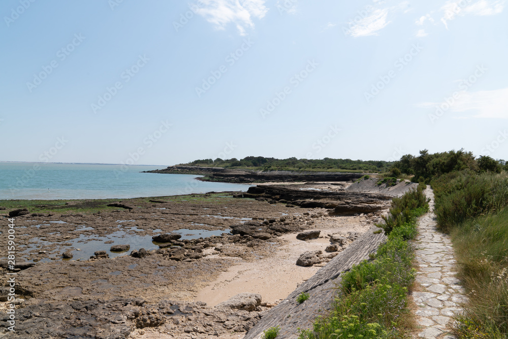 stone rock beach and dike of the island of Aix in France