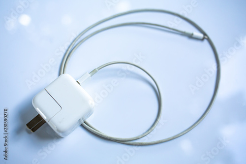 USB power adapter for devices, Charger Cable on white acrylic table background, Close up & Macro shot, Selective focus, Technology, Business concept