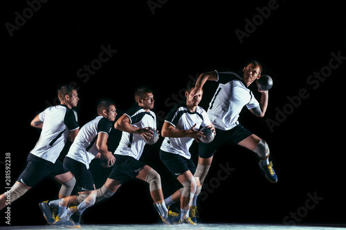 Caucasian young handball player in action and motion in mixed and strobe light on black studio background. Fit professional sportsman. Concept of sport, movement, energy, dynamic, healthy lifestyle.