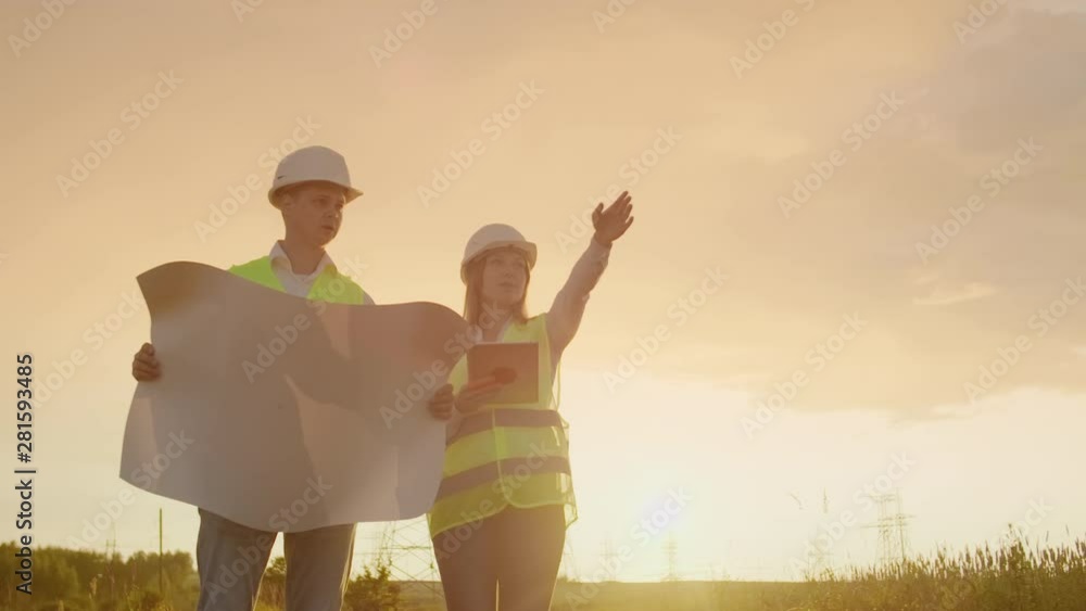 Engineer and supervisor with tablet PC and the drawings are about lines