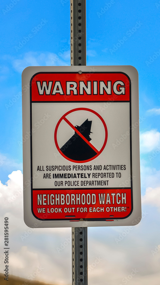 Vertical frame Close up of a Warning sign on a neighborhood against cloudy blue sky background Vertical frame Close up of a Warning sign on a neighborhood against cloudy blue sky background