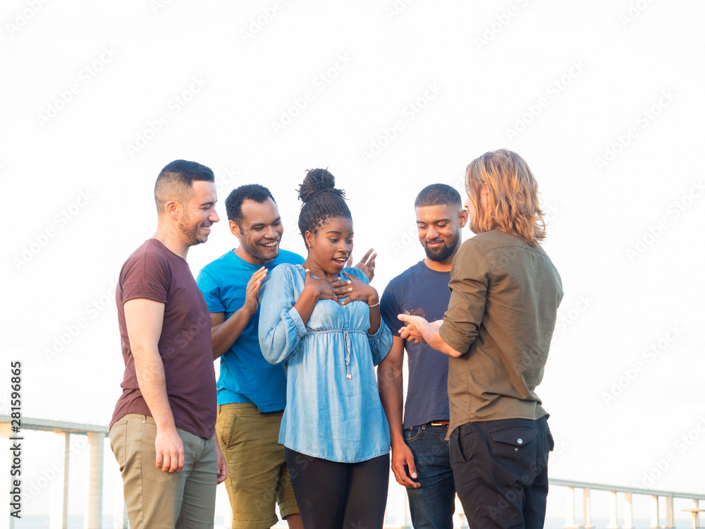 Smiling young people celebrating in summer park. Happy smiling friends standing in park with chocolate muffin. Concept of birthday celebration concept Smiling young people celebrating in summer park. Happy smiling friends standing in park with chocolate muffin. Concept of birthday celebration concept