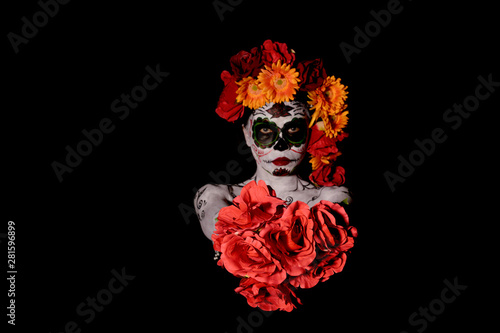Fototapeta Naklejka Na Ścianę i Meble -  Halloween, Day of the Dead body paint on woman giving flower to you on black background