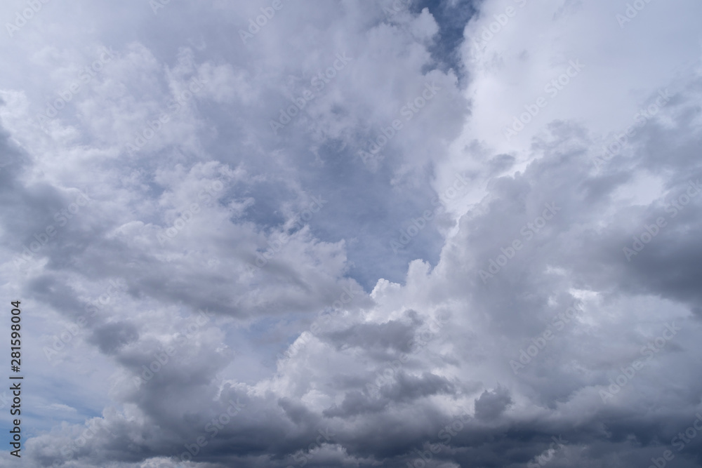 Towering cumulonimbus clouds accompanied by smaller cumulus clouds