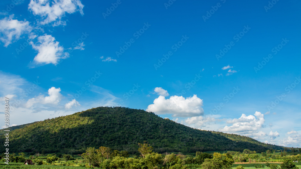 Mountains and tree with beautiful blue sky and clouds.