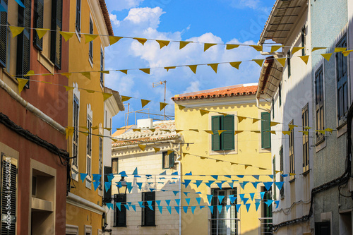 Street of Alaior town, decorated for festa with bunting colorful flags, Menorca, Balearic islands, Spain 