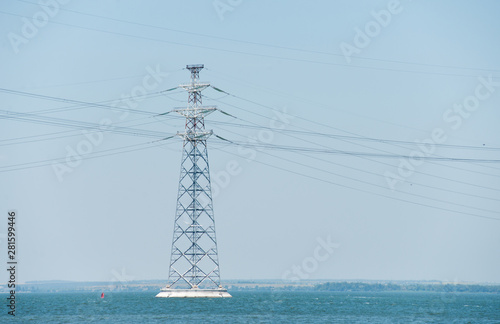 High-voltage pylon of power lines on the river