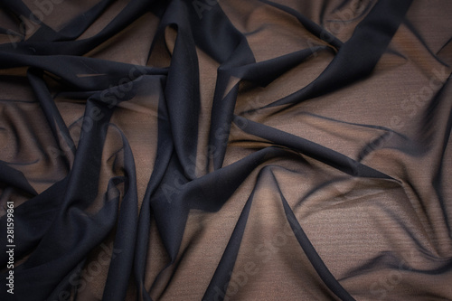 The texture of the synthetic fabric is black. Background, pattern. photo