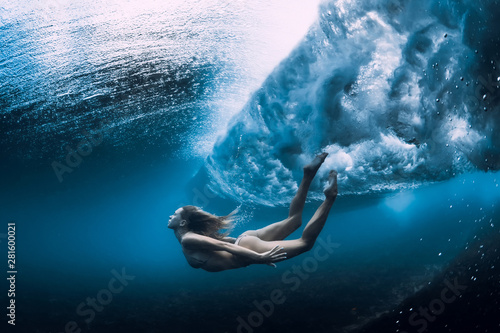 Woman swim underwater with ocean wave. © artifirsov