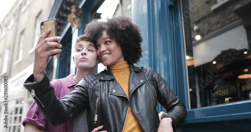 Young adult lesbian couple taking selfie in London photo