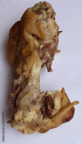 Boiled pig leg close-up on a white background.