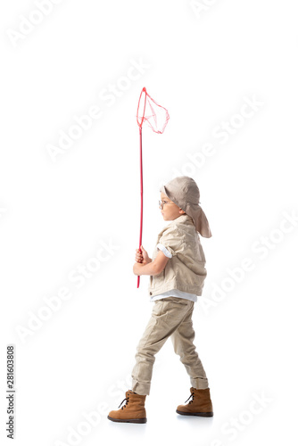 full length view of explorer boy in glasses holding butterfly net on white