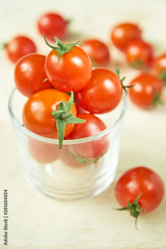 Fresh cherry tomatoes on white wooden table. Organic vegetables, healthy and dieting food, soft focus Fresh cherry tomatoes on white wooden table. Organic vegetables, healthy and dieting food, soft focus