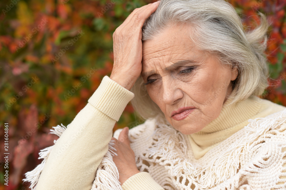 Portrait of sad senior woman in autumn park Portrait of sad senior woman in autumn park