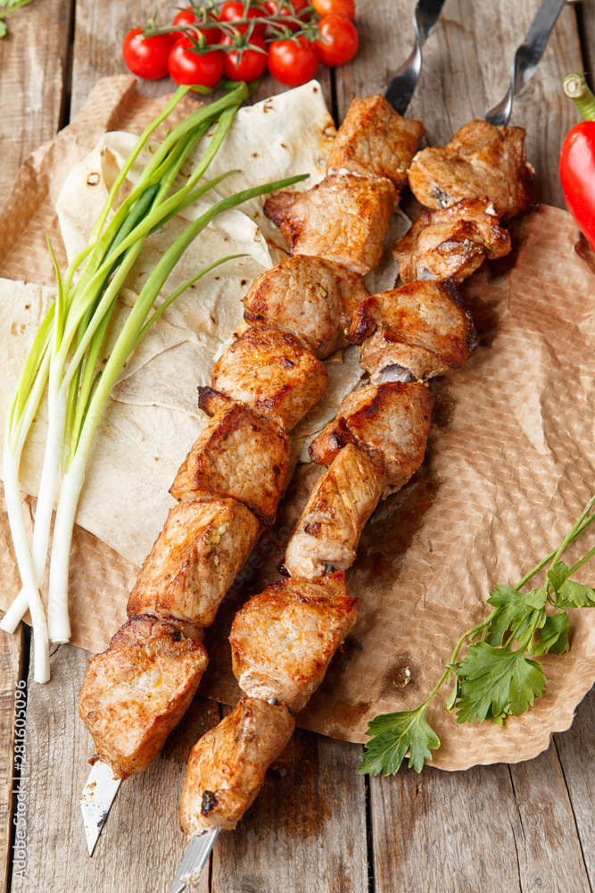 pork skewers on a wooden table, selective focus