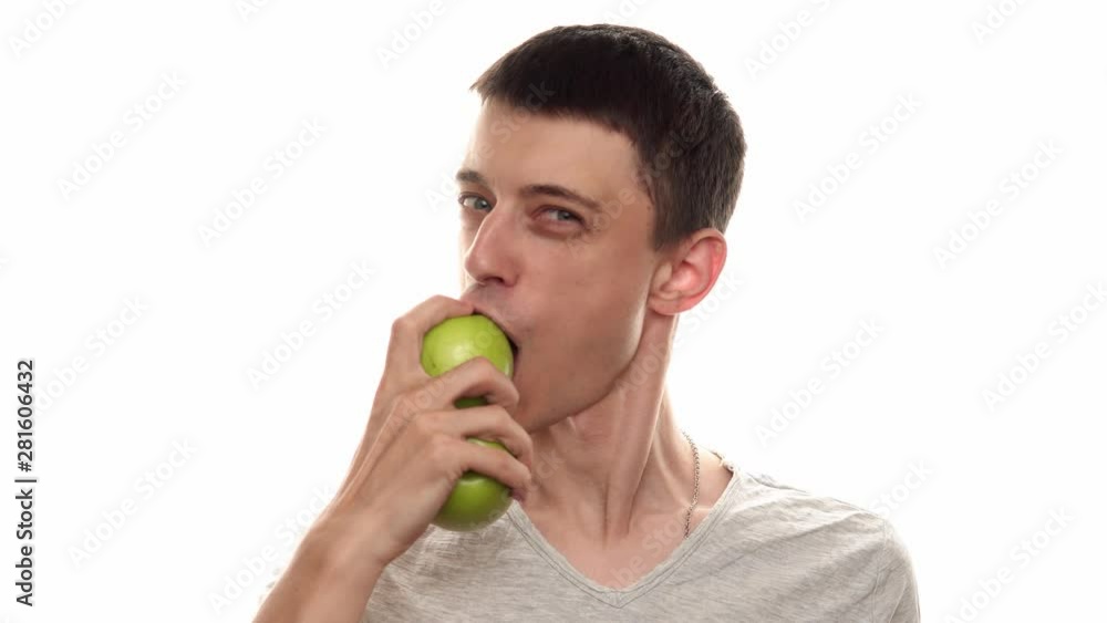 A man juggles apples and then eats them - White background - healthy food A man juggles apples and then eats them - White background - healthy food